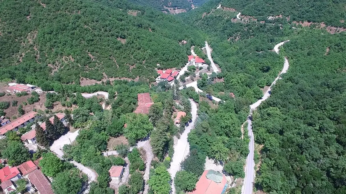 Aerial view of the Loutra Smokovou spa village and winding roads in a forested ravine