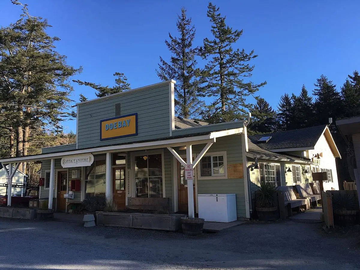 Historic Doe Bay General Store, a clapboard building with a covered porch beneath tall firs