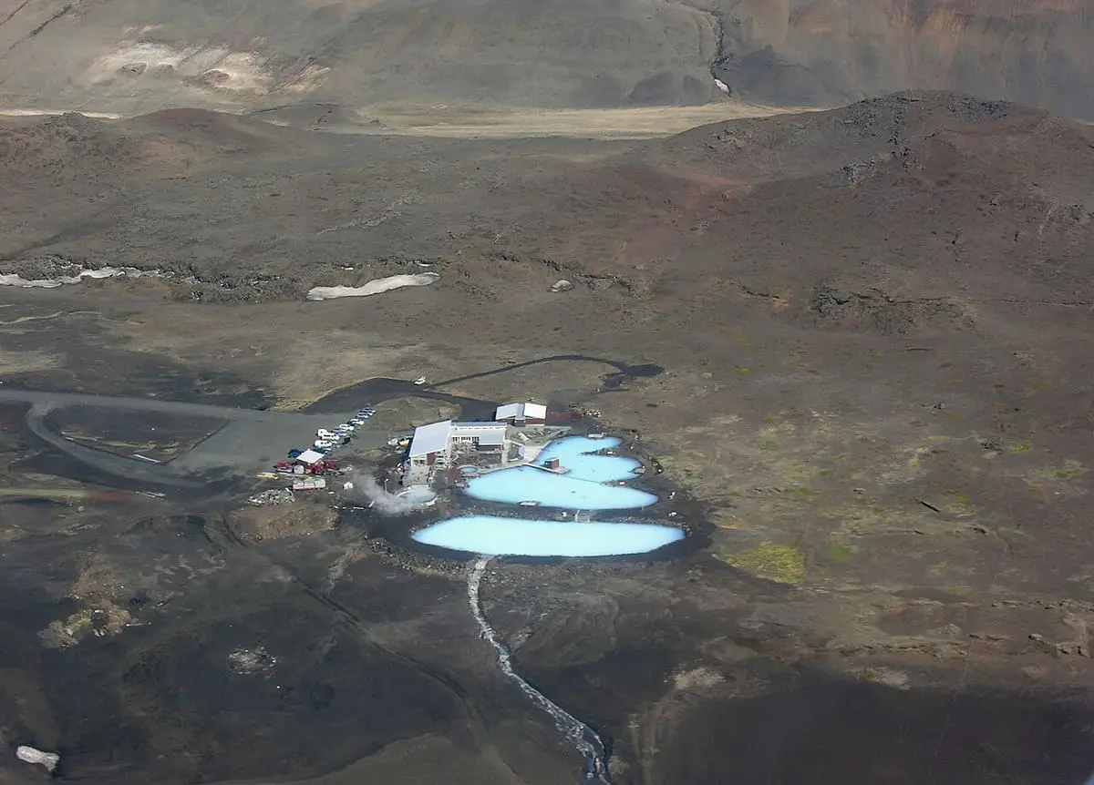 Aerial view of the Mývatn nature baths, pale blue pools set in dark lava fields