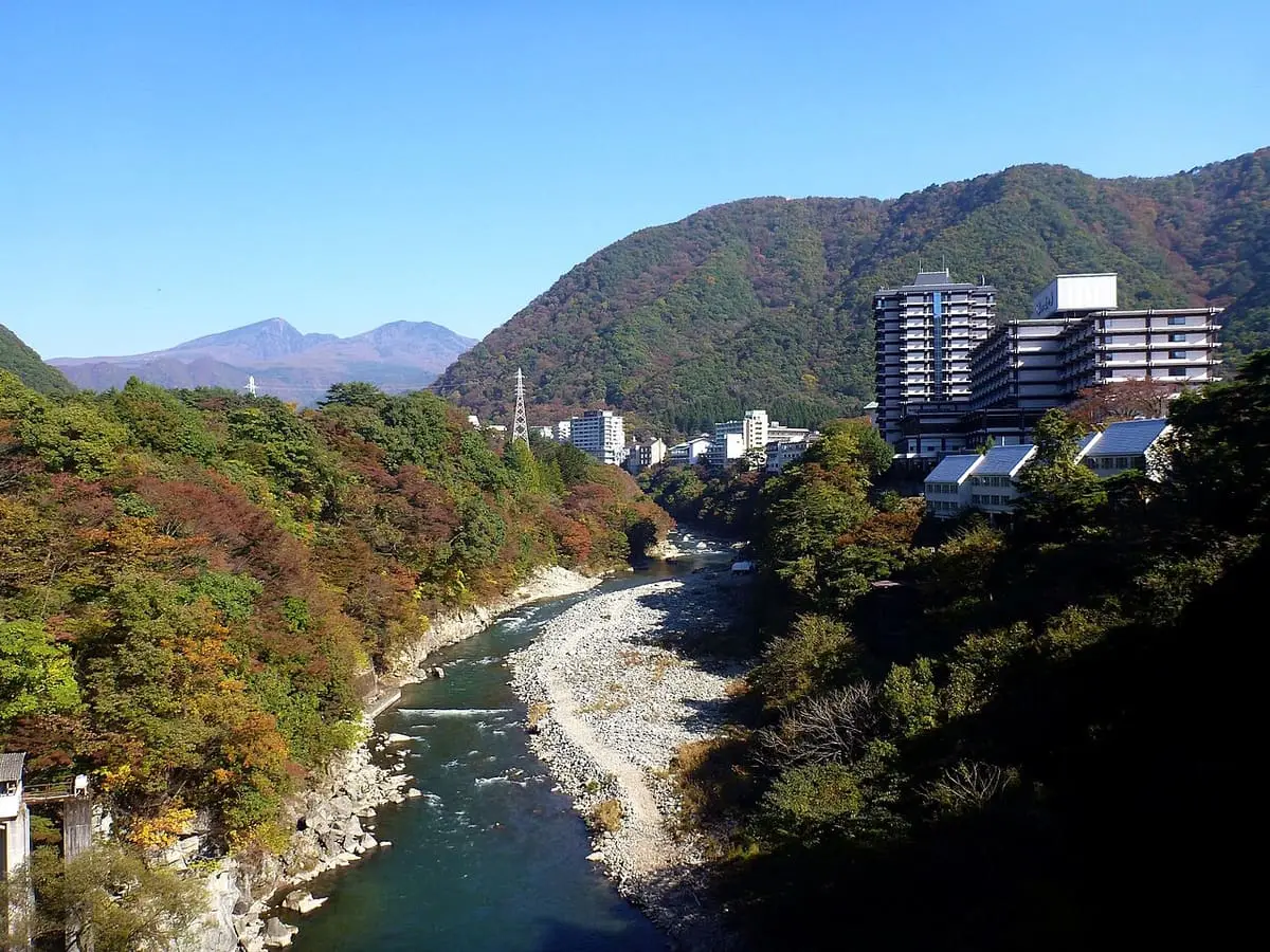 Kinugawa River winding through autumn colored hills past hotels at Kinugawa Onsen