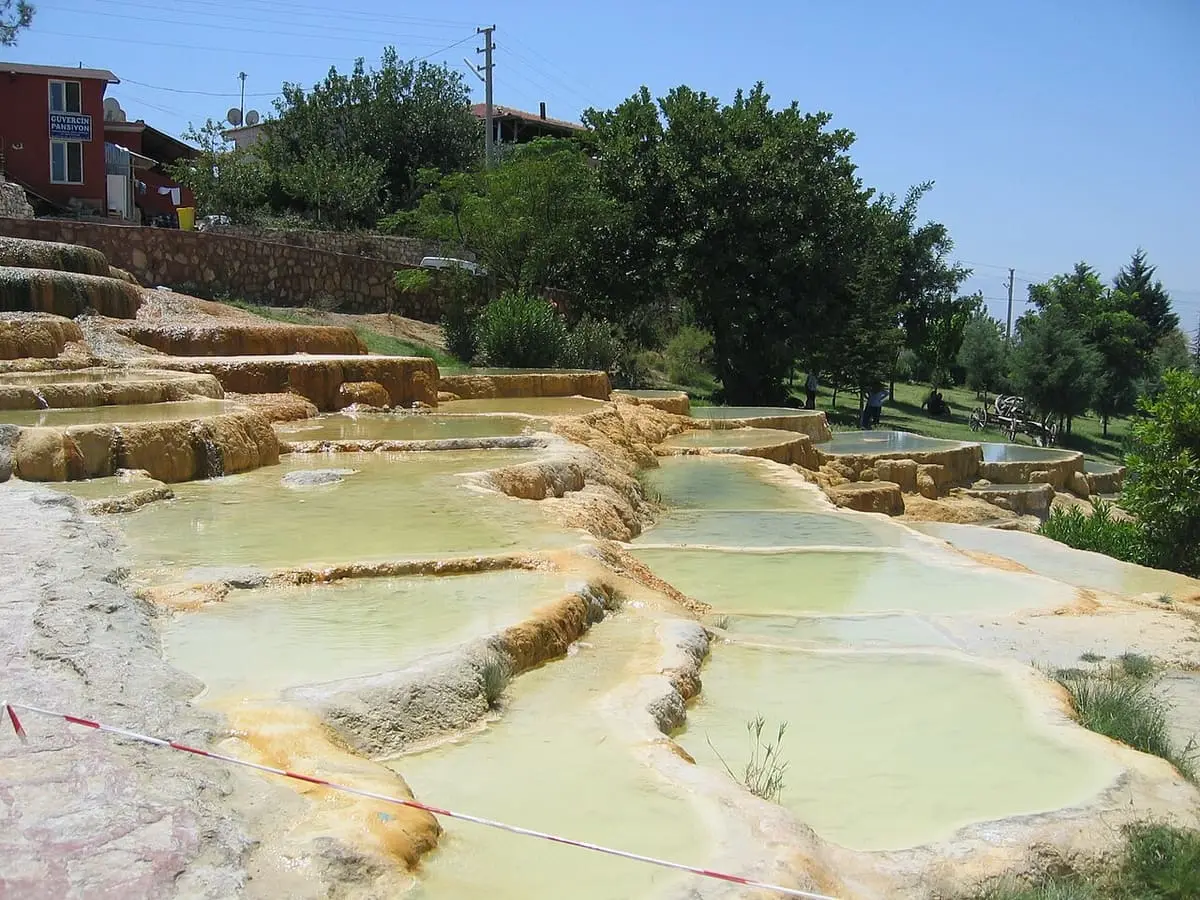 Pale green pools on stepped travertine terraces at the Karahayıt red springs