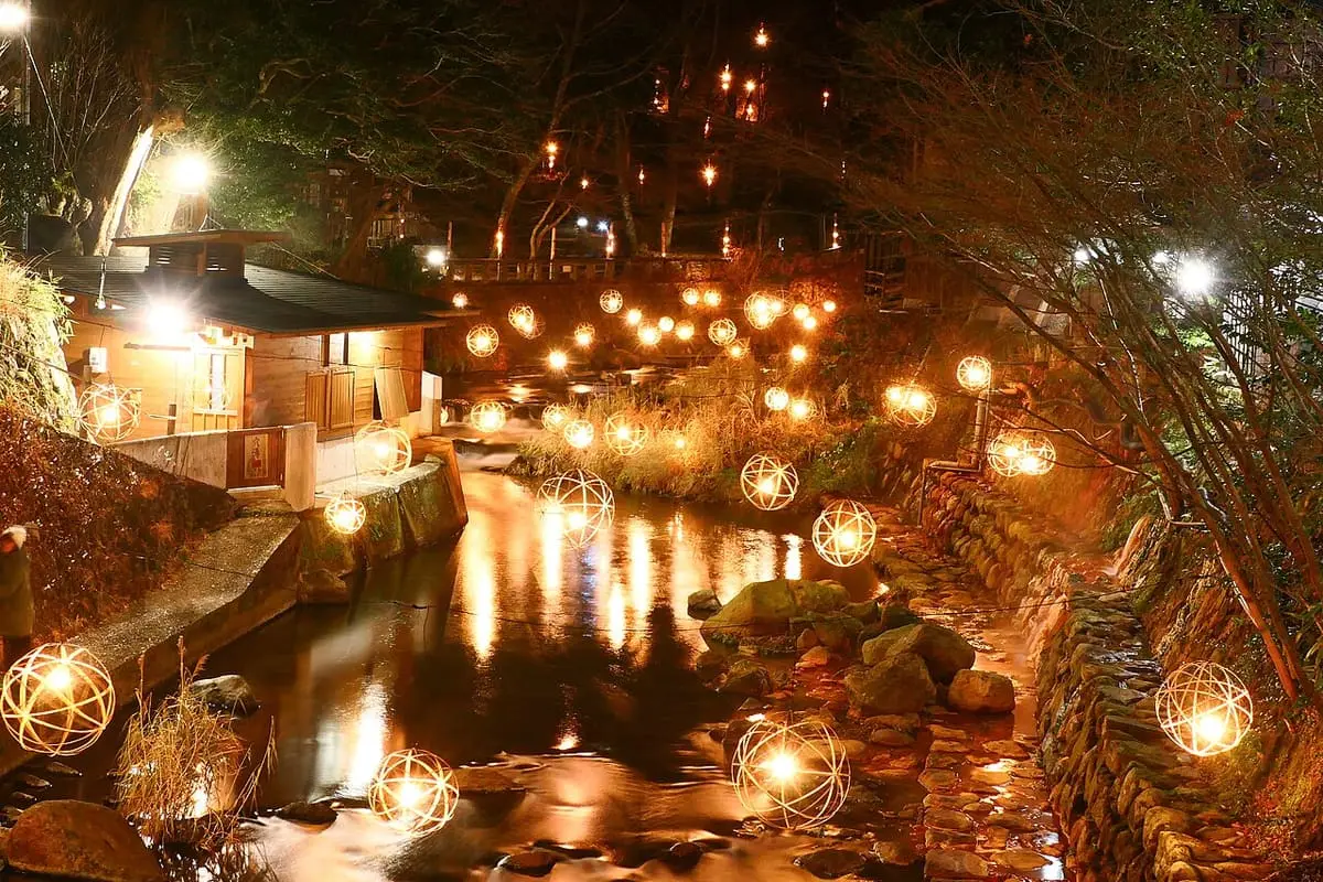 Glowing ball lanterns along the Tanohara River at Kurokawa Onsen beside the Anayu bathhouse