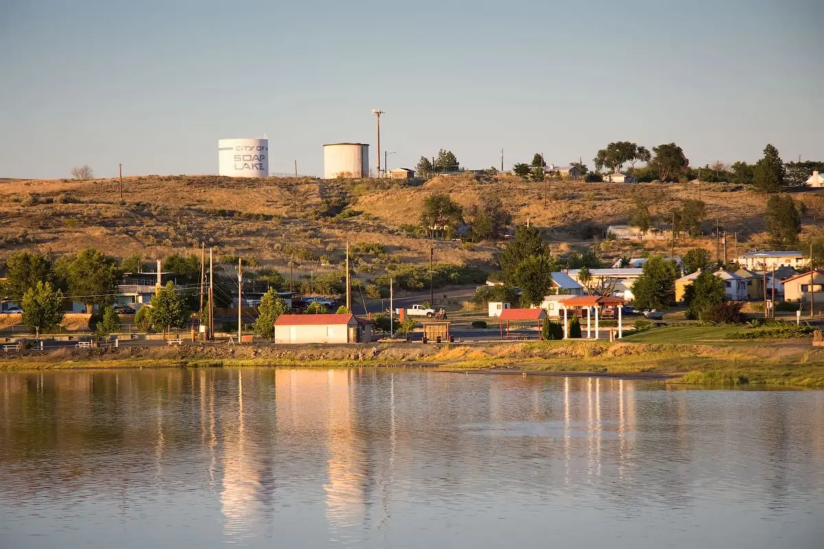Town of Soap Lake and its water towers reflected in the still lake at dusk