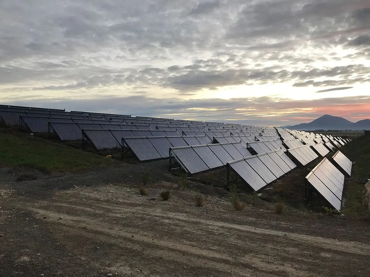 Rows of solar collectors that heat the Opuke Thermal Pools under a cloudy evening sky