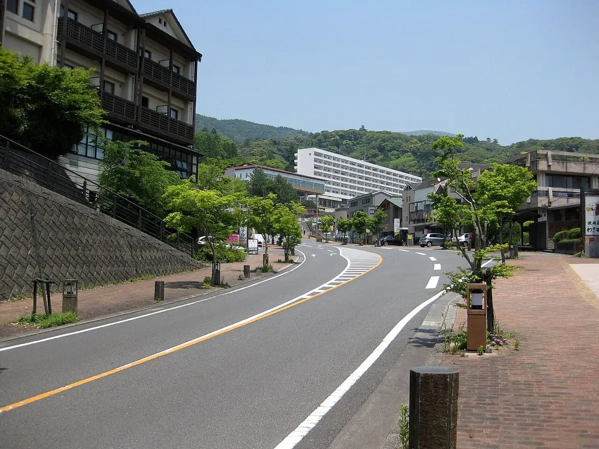 Main road through Maruo Onsen in the Kirishima hot spring area with hotels and greenery