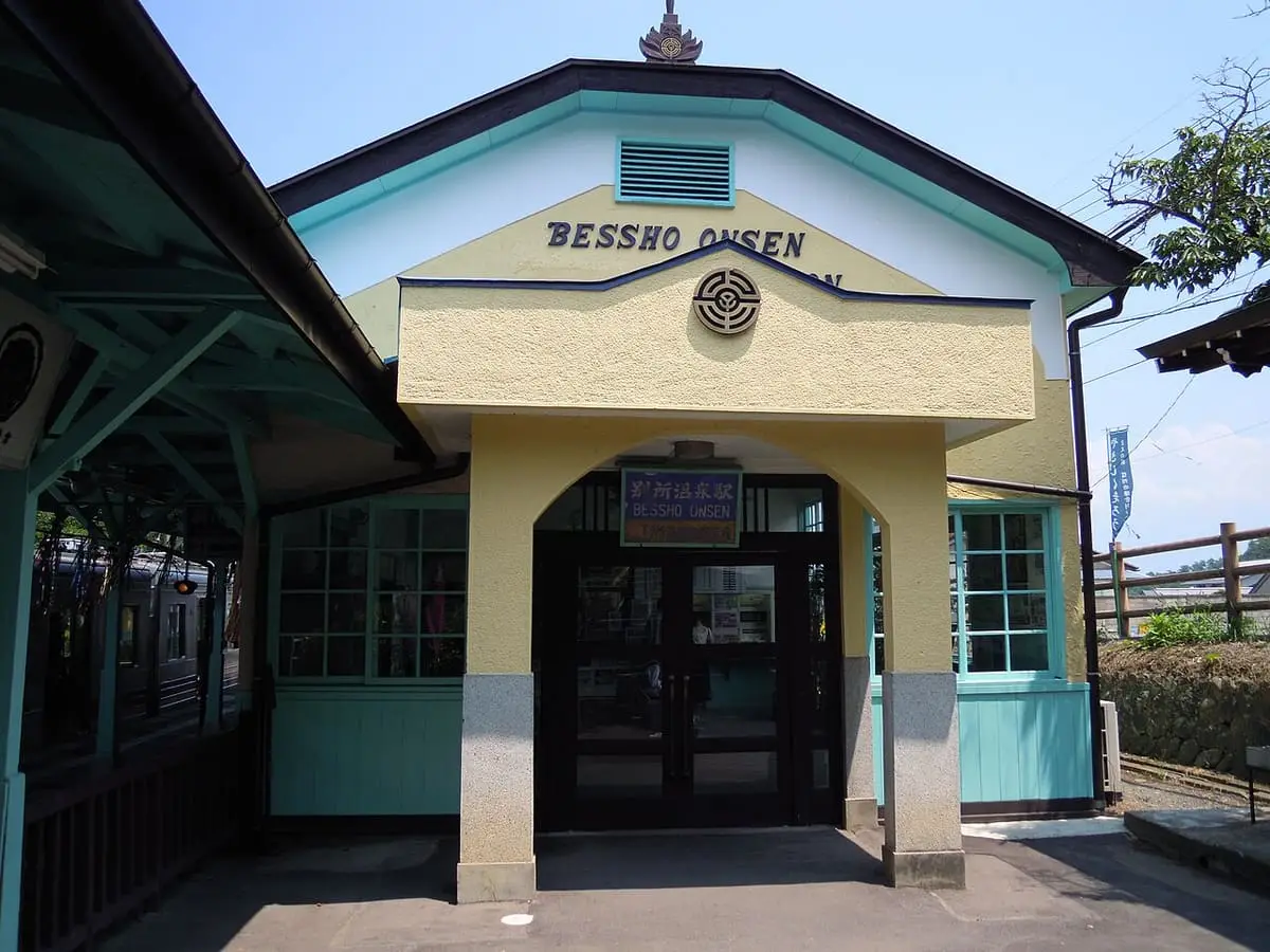 Pale yellow and green front of the historic Bessho Onsen Station building