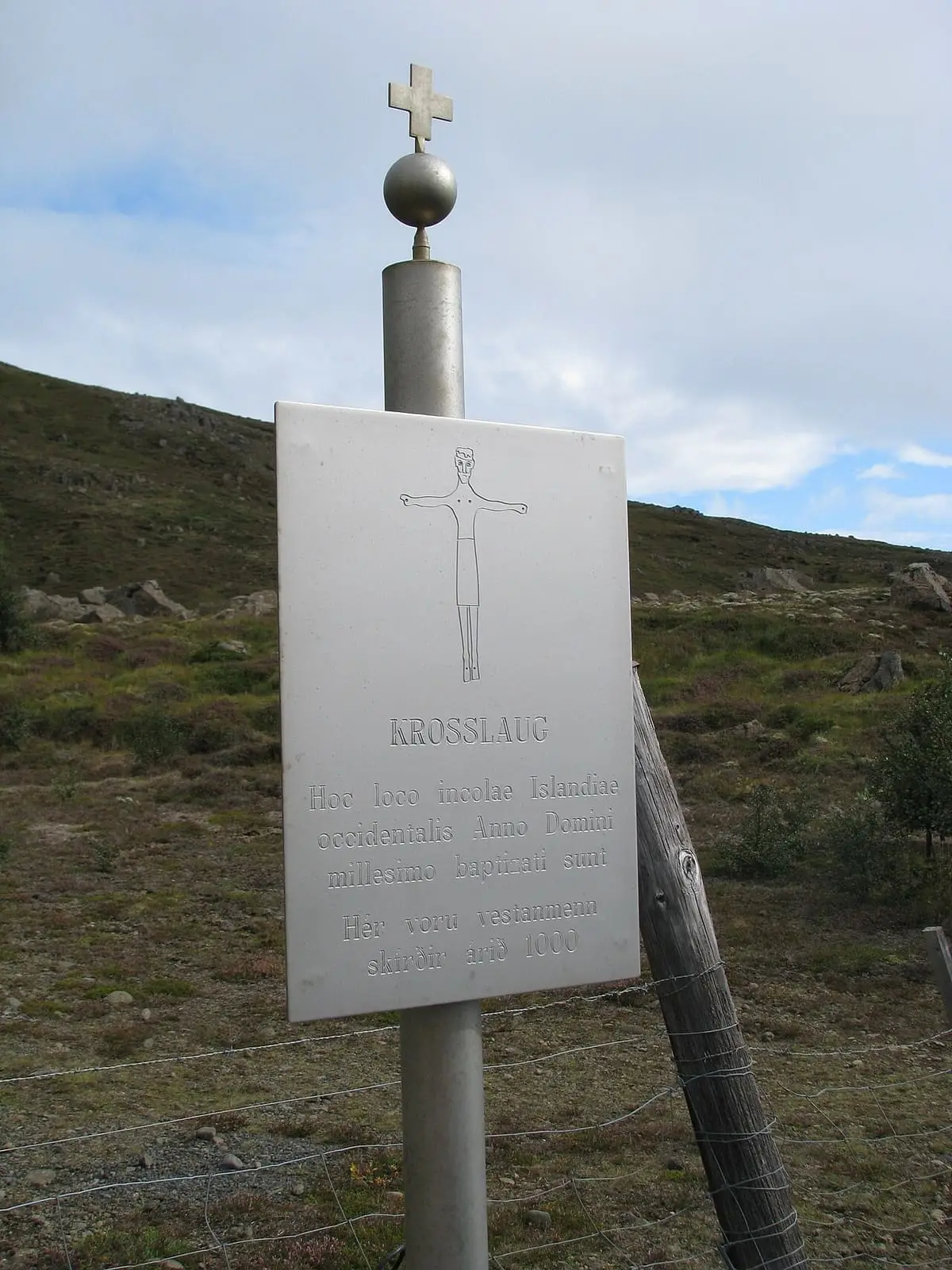 Memorial sign with a cross marking the historic Krosslaug baptism pool
