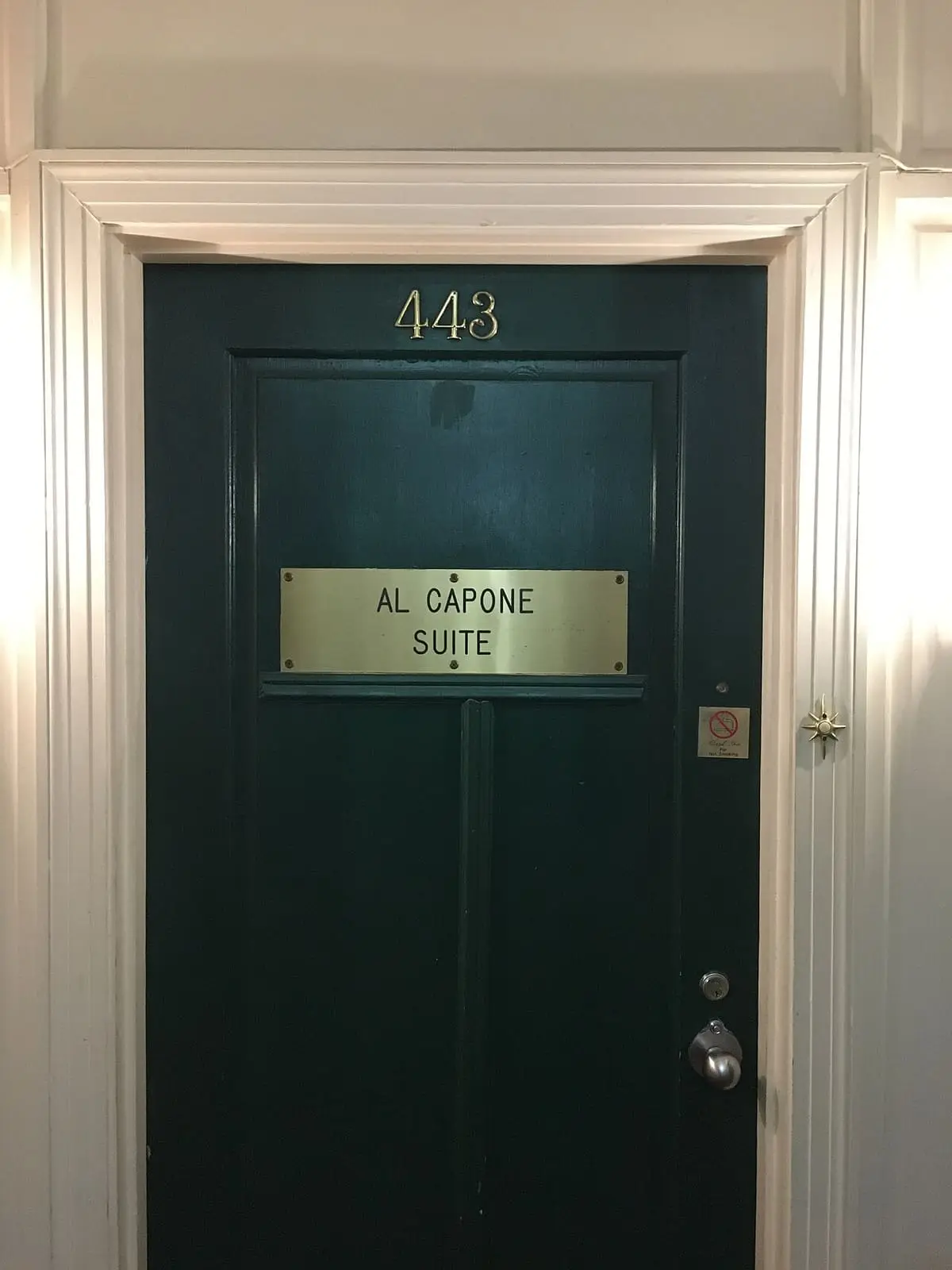 Green door of Room 443 at the Arlington Hotel with an Al Capone Suite nameplate
