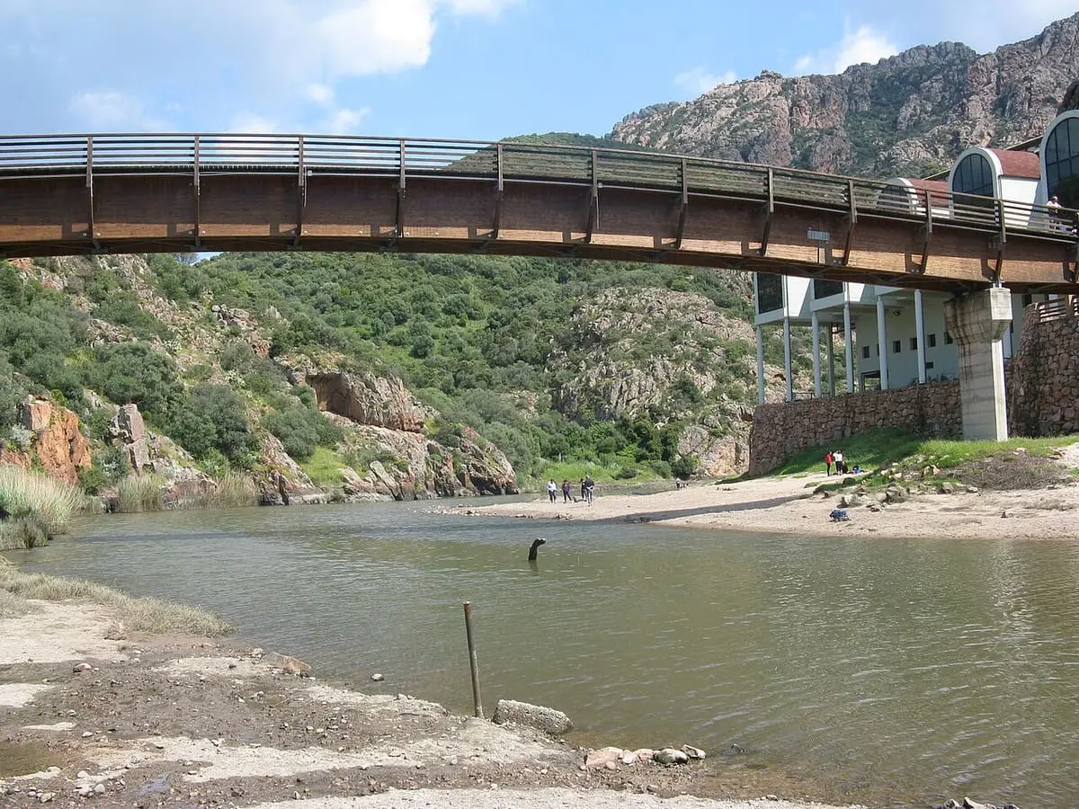 Footbridge spanning the Coghinas river beside the Casteldoria spa building