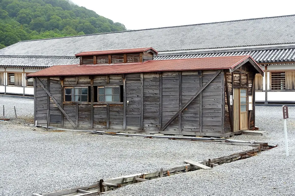 Wooden bath hut on the gravel grounds of Bodaiji temple at Mount Osore