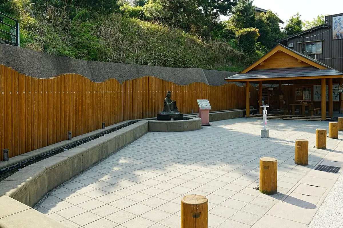 Paved plaza with a footbath and wooden pavilion in Tamatsukuri Onsen