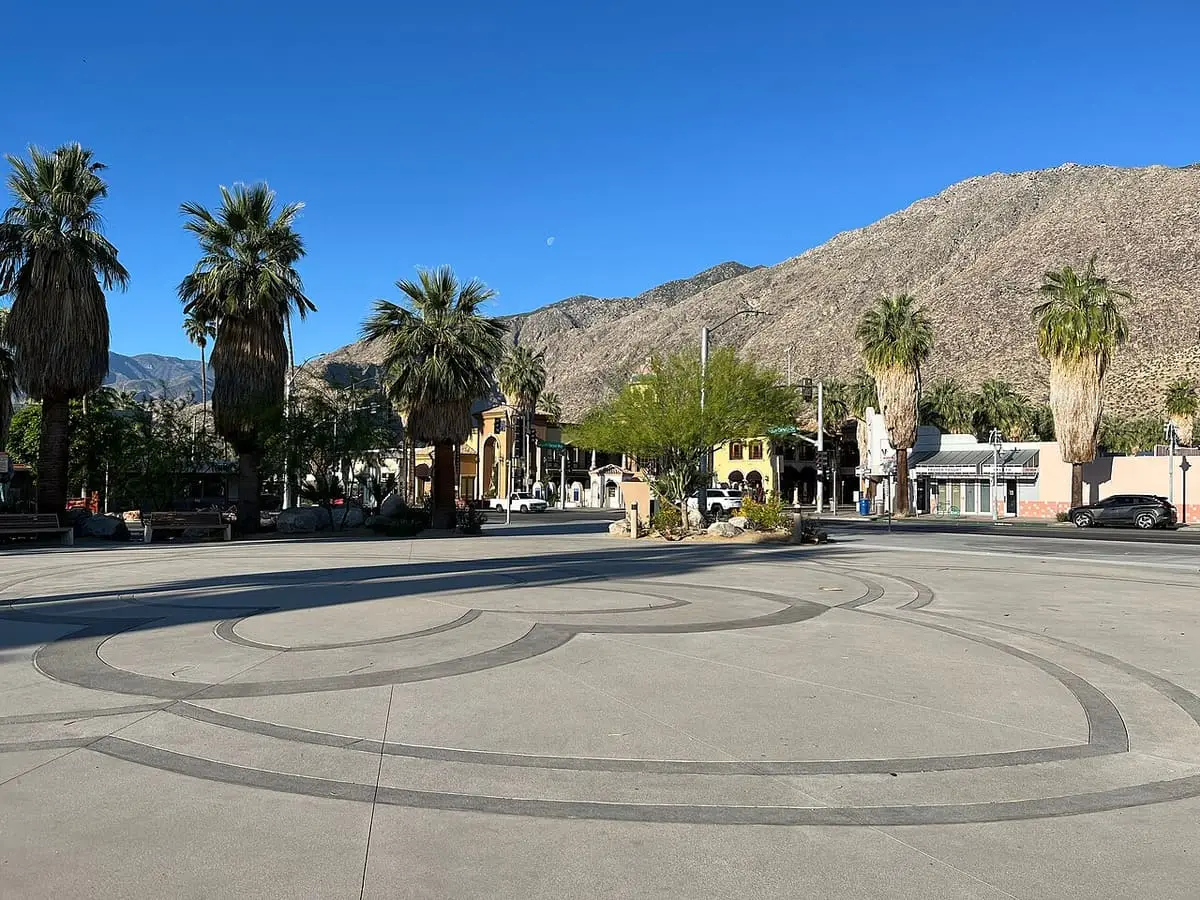 Agua Caliente Cultural Plaza with fan palms and the San Jacinto Mountains above downtown Palm Springs