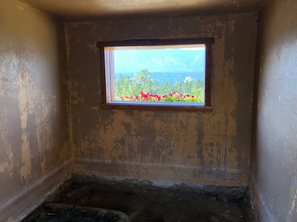 Bare interior of the old bathhouse at Fairmont Hot Springs with a small window