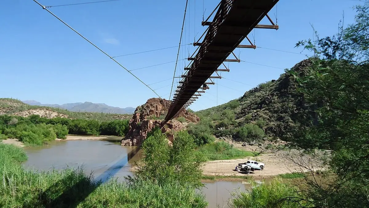 Underside of the Sheep Bridge suspension footbridge over the Verde River and reedy banks