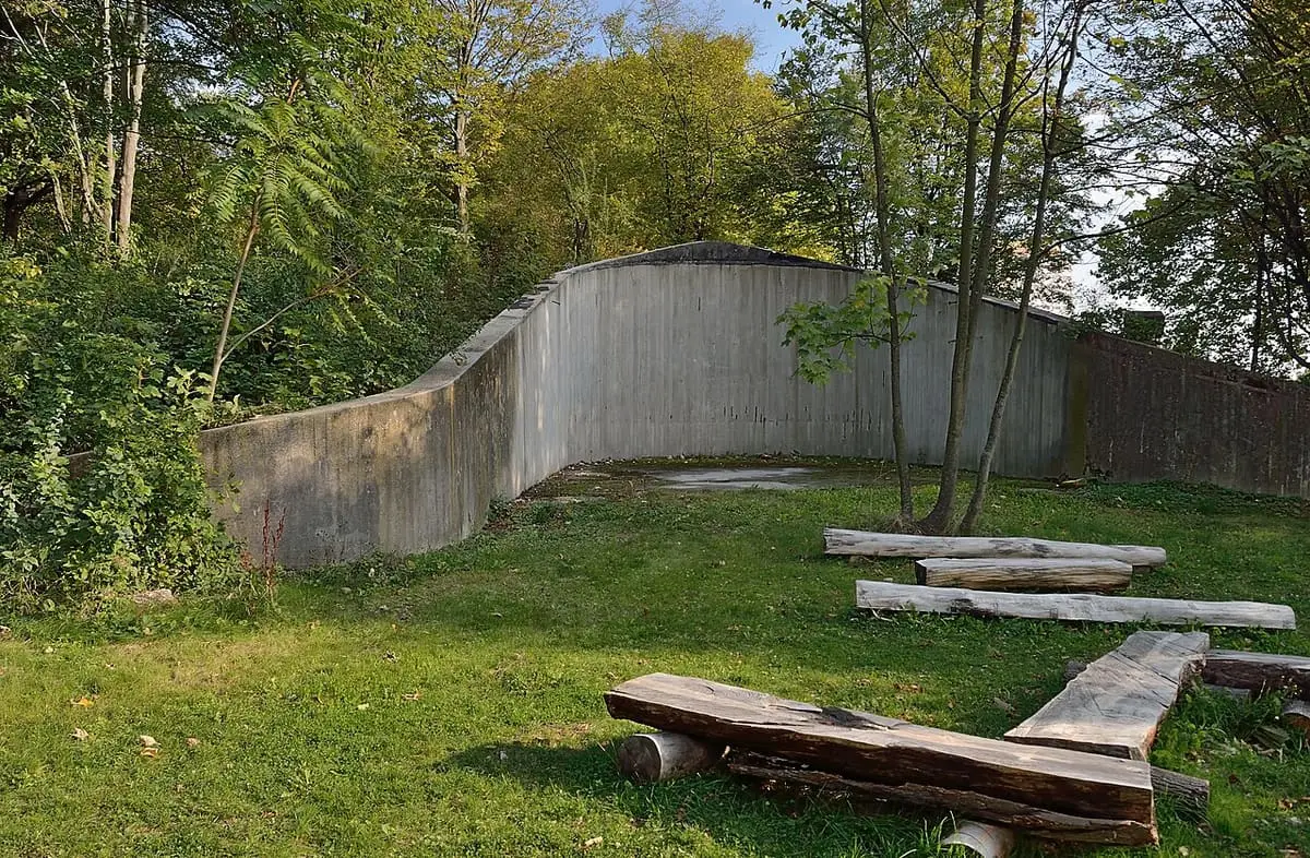 Sealed old thermal water well among trees in Kurpark Oberlaa that once supplied the baths