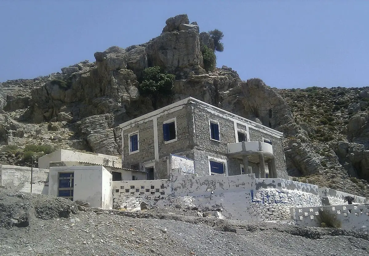 Old stone building on the rocky slope above Therma beach near Agios Fokas, Kos