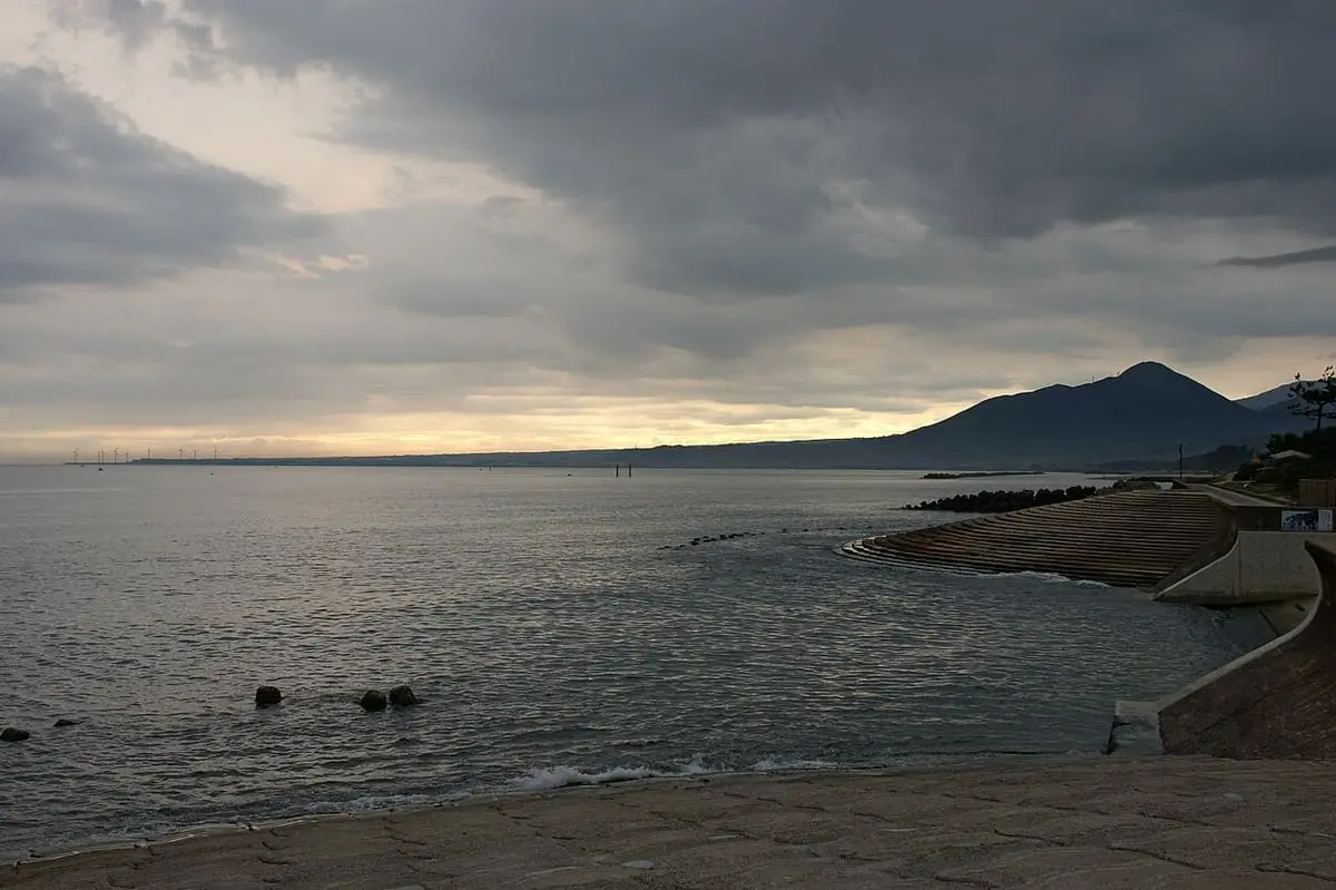 Evening coastline at Kaike Onsen with Mount Daisen on the horizon under dramatic clouds