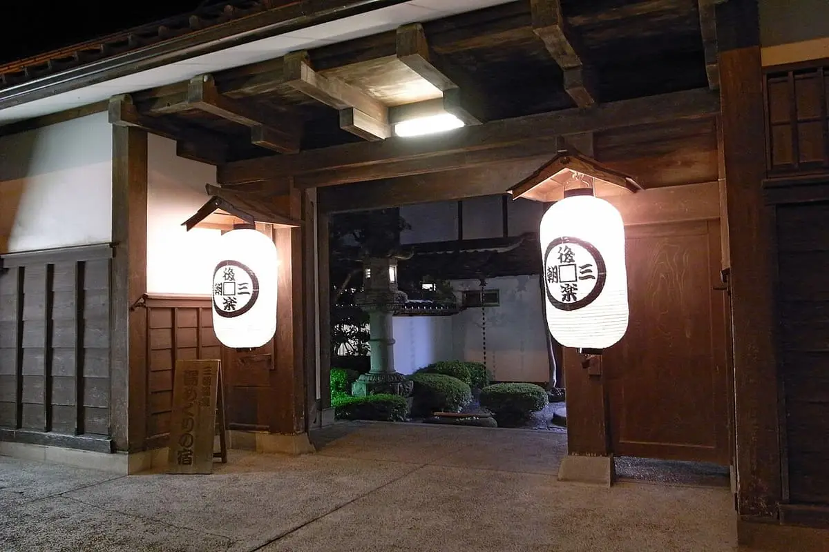 Inn entrance with paper lanterns and a stone path at Misasa Onsen