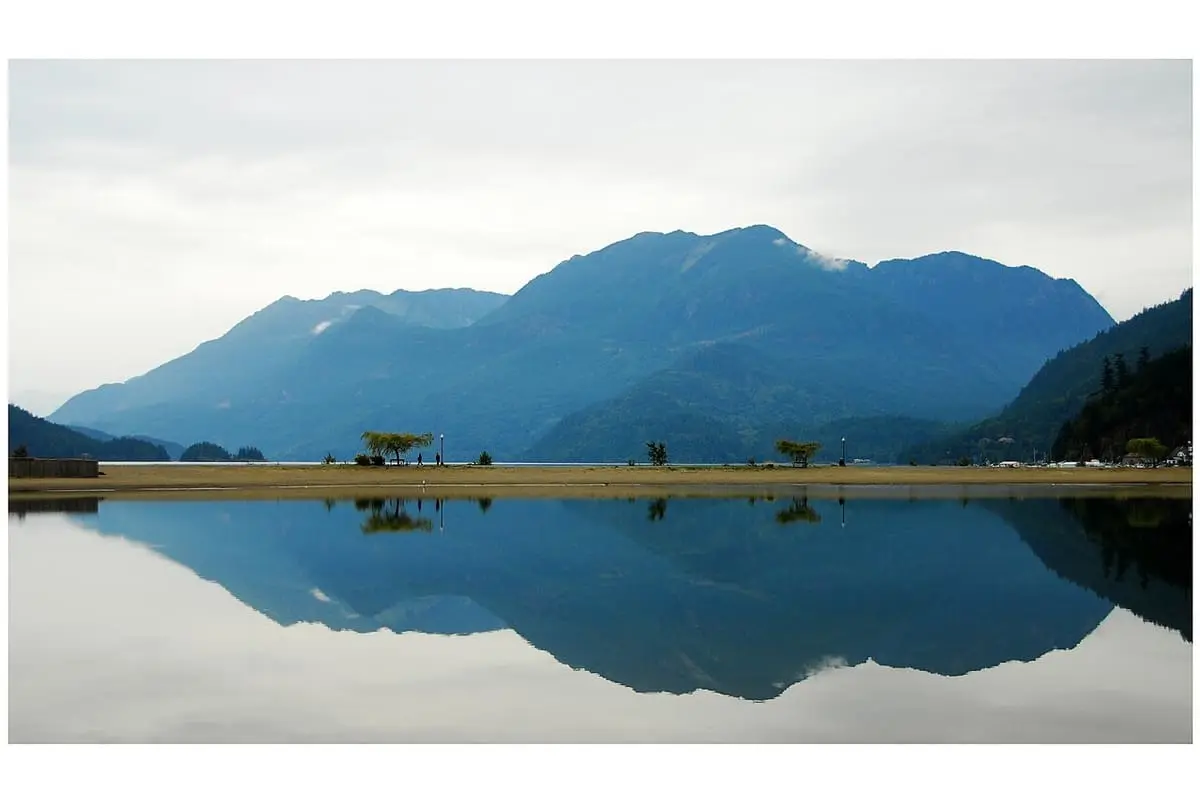 Mountains reflected in calm water at Harrison Hot Springs