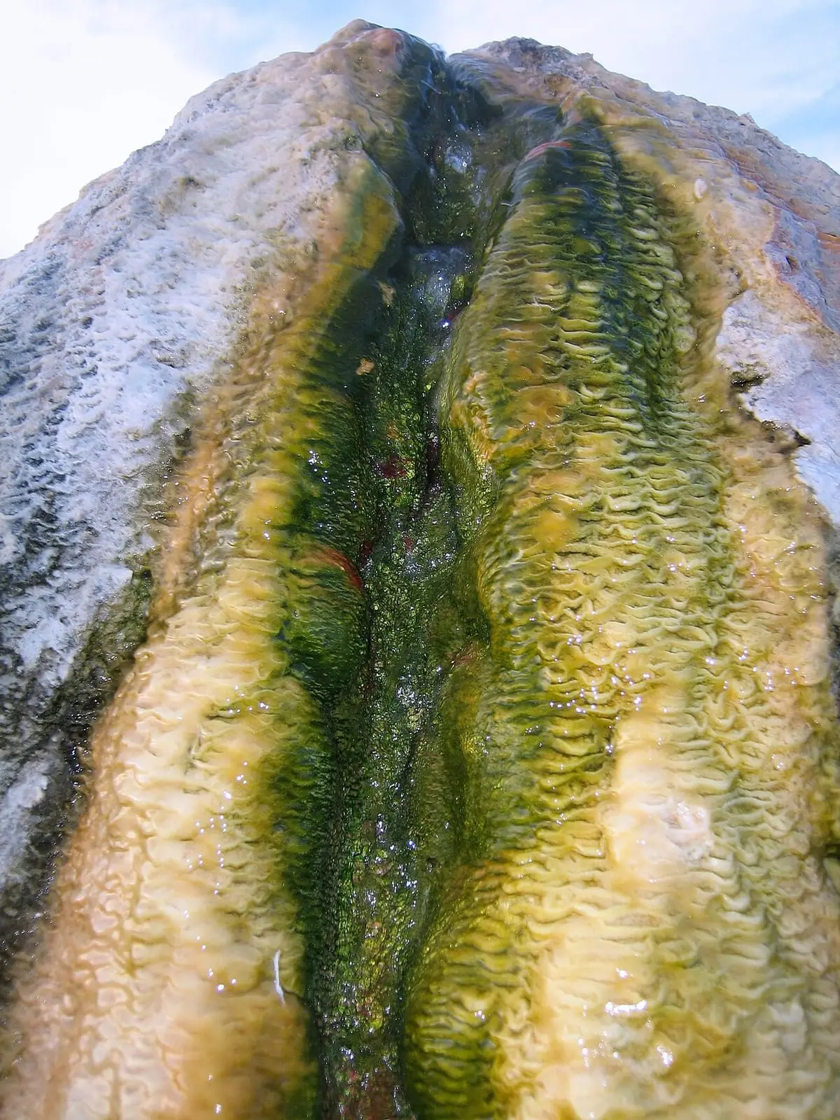 Close view of the travertine ridge with green and orange mineral streaks near Bridgeport