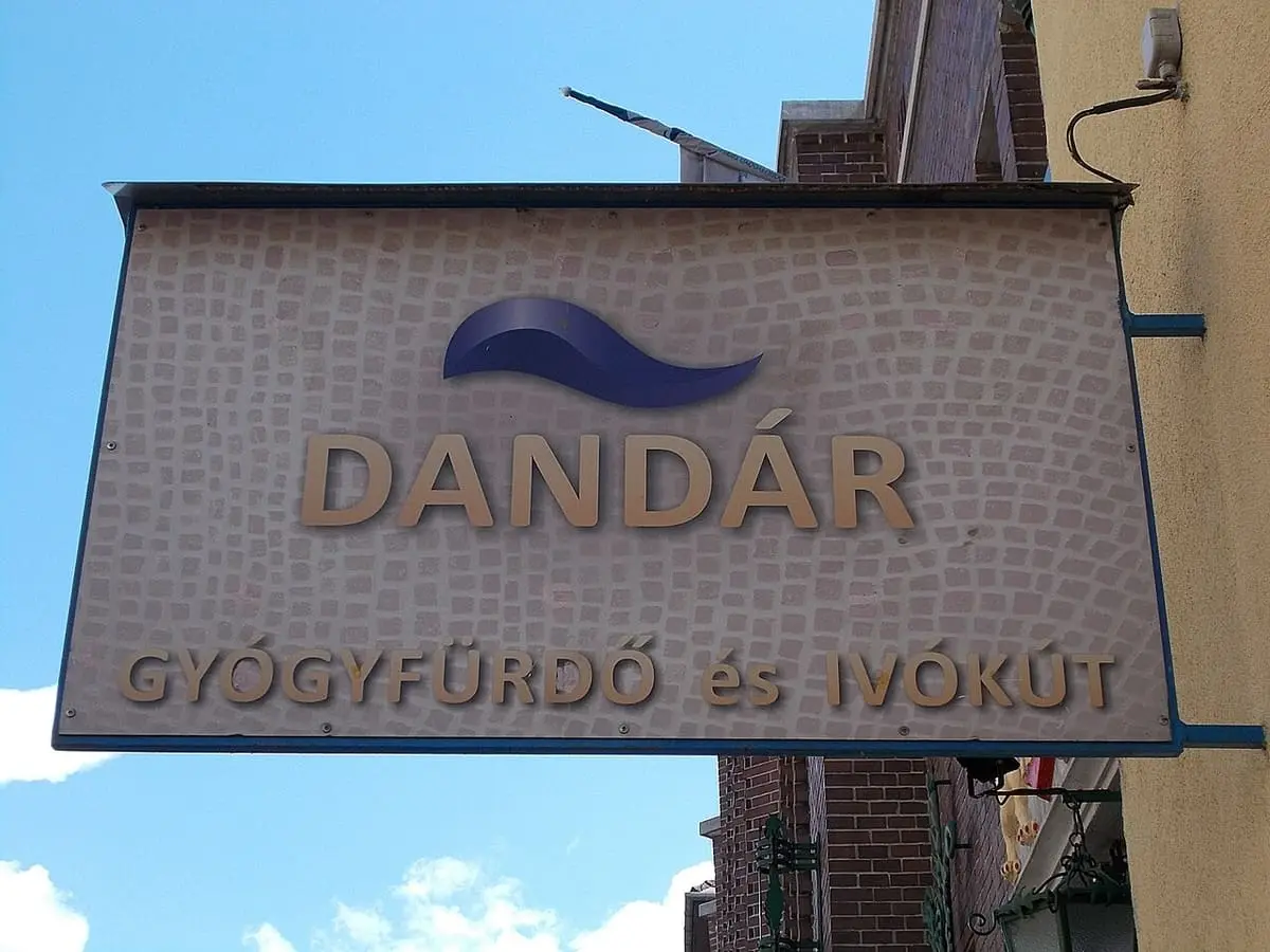 Hanging sign for Dandár Gyógyfürdő és Ivókút on the bath building in Budapest