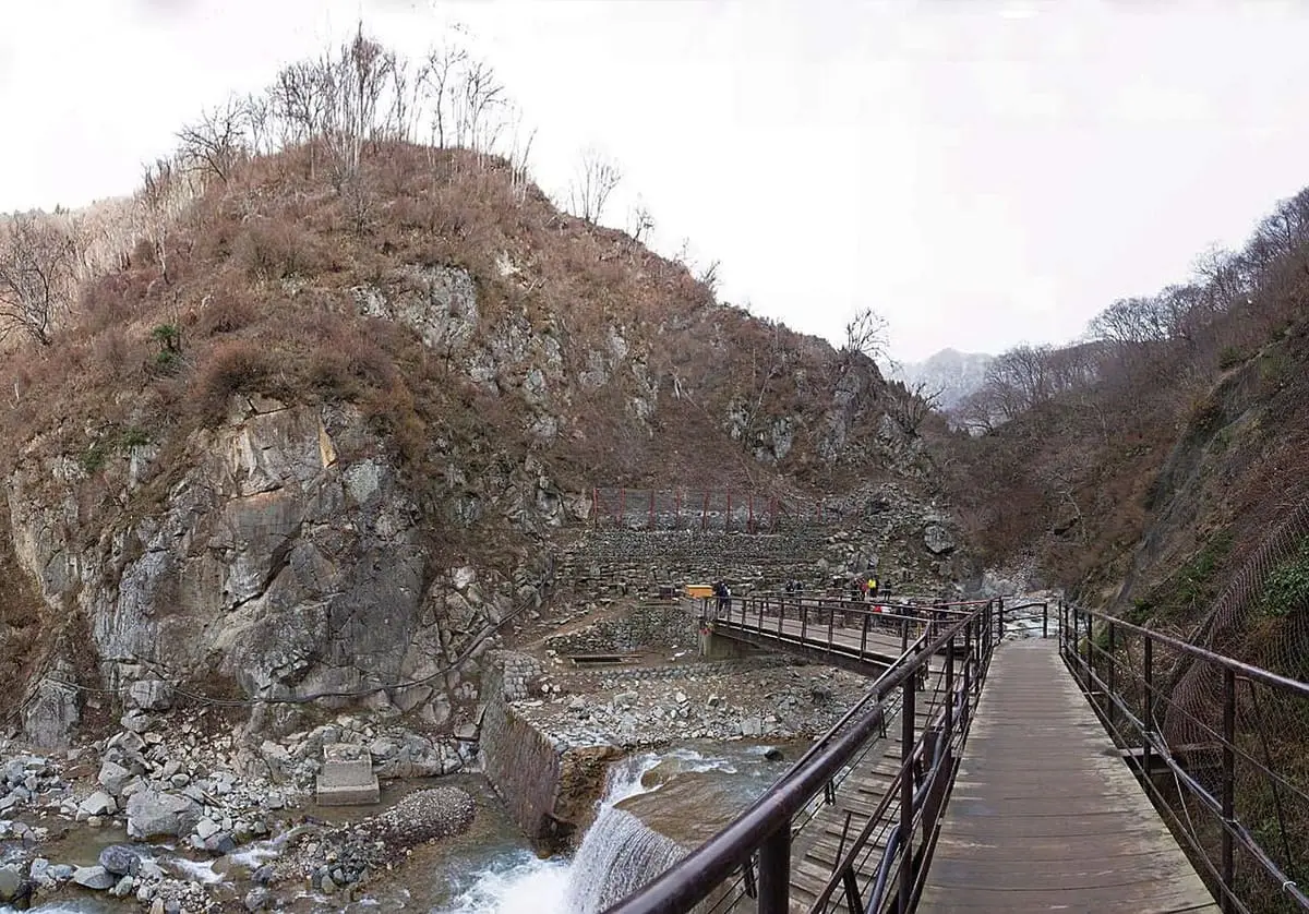 Wooden walkway along the rocky Yokoyu River gorge leading to Jigokudani Monkey Park