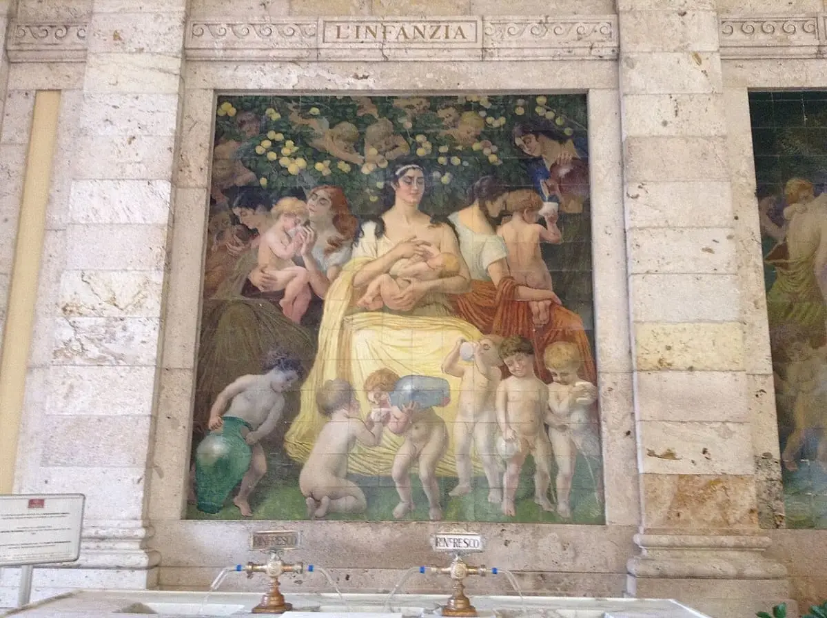 Painted tile mural on a stone wall at the Terme Tettuccio in Montecatini
