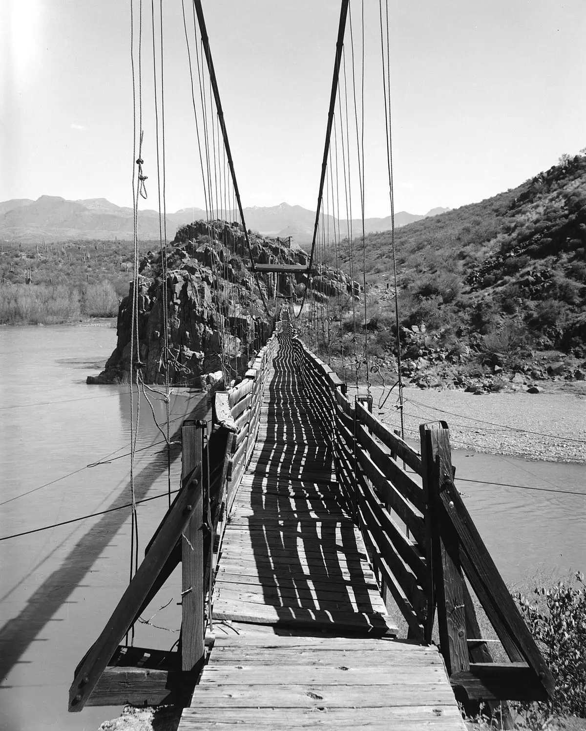 Black and white view along the original wooden Sheep Bridge deck over the Verde River
