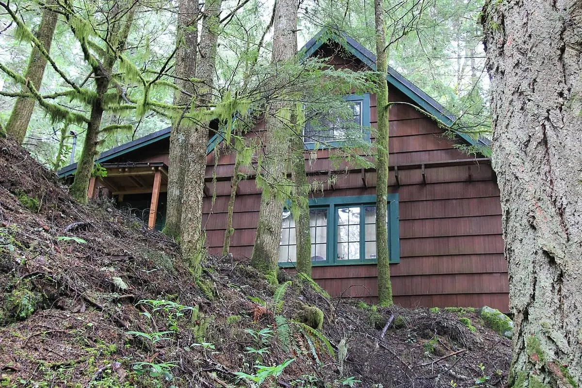Brown shingled cabin among mossy trees at Bagby Hot Springs in Mount Hood National Forest