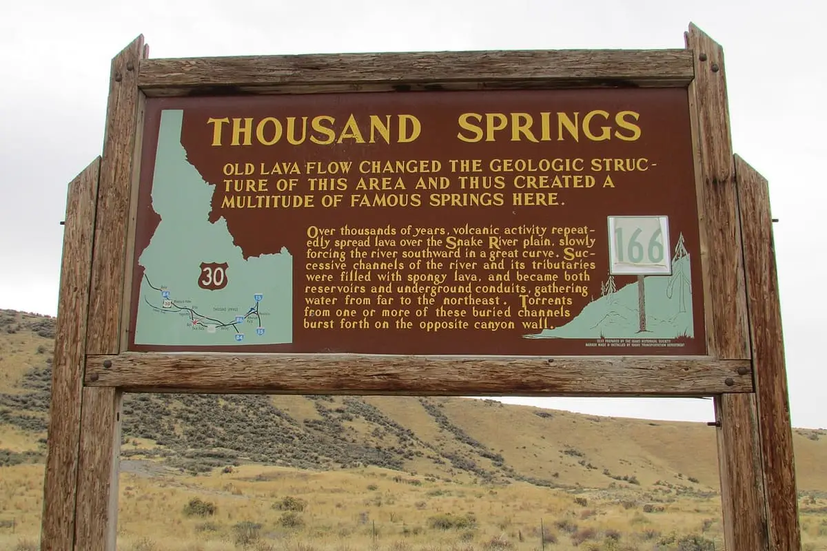 Thousand Springs historical marker sign explaining the springs that burst from the canyon wall
