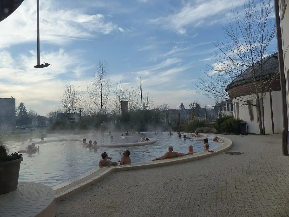 Steaming outdoor thermal pool at Hagymatikum on a cold sunny day