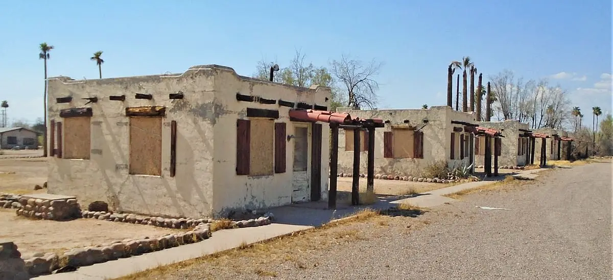 Row of shuttered adobe style motel units at the closed Buckhorn Baths in Mesa