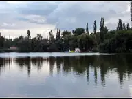 Sóstó lake reflecting a line of poplars beside the Sóstógyógyfürdő spa district in Nyíregyháza
