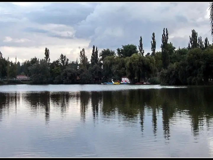 Sóstó lake reflecting a line of poplars beside the Sóstógyógyfürdő spa district in Nyíregyháza