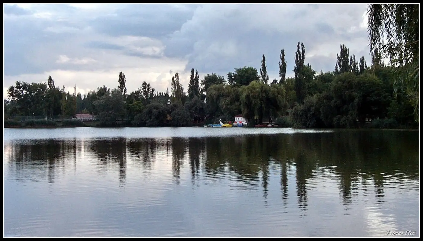 Sóstó lake reflecting a line of poplars beside the Sóstógyógyfürdő spa district in Nyíregyháza