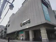 Exterior of the Thermae-yu Shinjuku spa building on a street corner in Kabukicho, Tokyo
