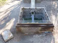 Sulphur spring water running from a pipe into a small concrete basin at Kyllini