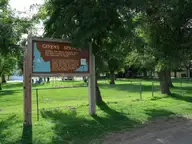 Givens Springs historical marker on the shaded lawn of the Givens Hot Springs picnic grounds