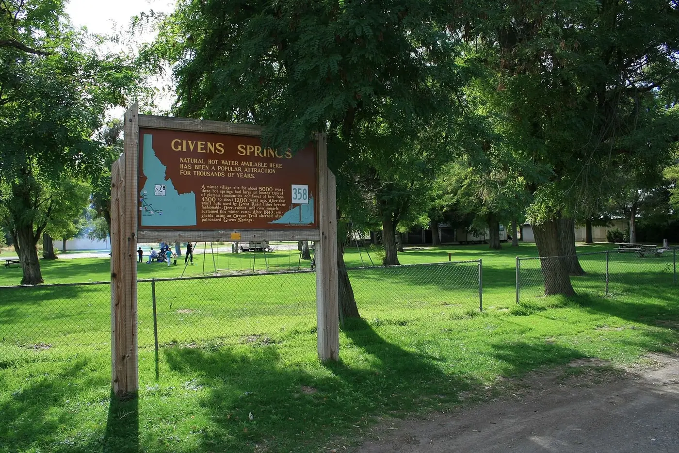 Givens Springs historical marker on the shaded lawn of the Givens Hot Springs picnic grounds