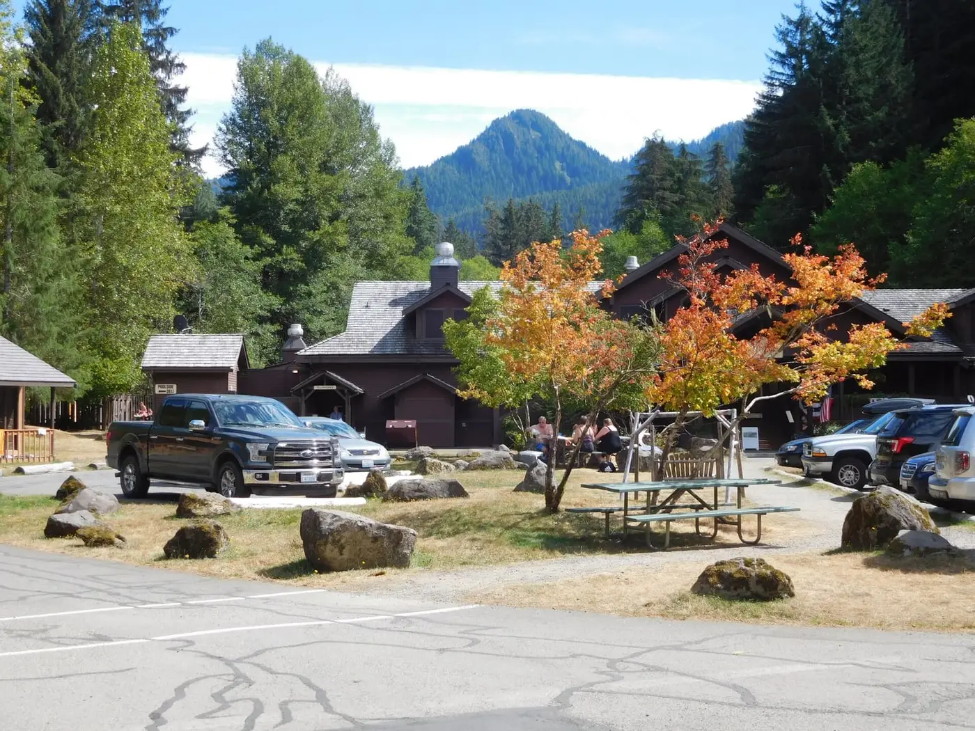 Sol Duc Hot Springs Resort lodge among evergreens and autumn maples below a forested peak