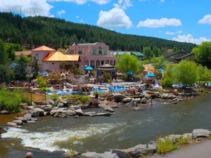 The Springs Resort soaking pools and pink buildings along the San Juan River in Pagosa Springs