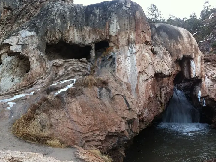 Soda Dam travertine formation with the Jemez River pouring through a gap into a pool
