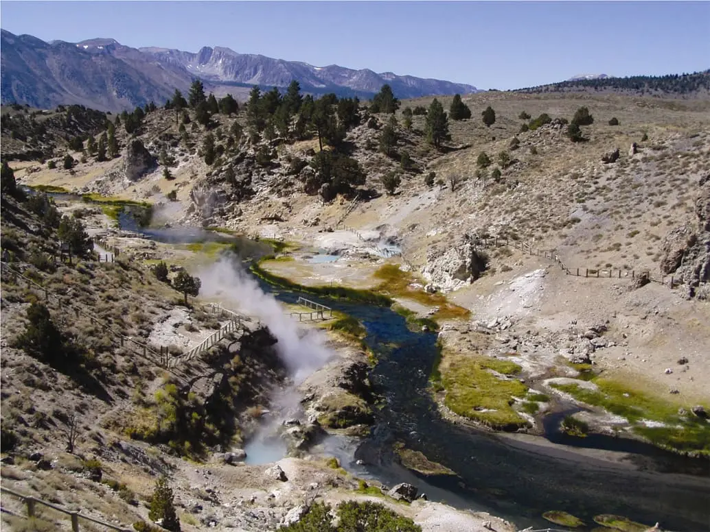 Steam rising from hot springs along Hot Creek as it winds through a gorge below the Sierra Nevada