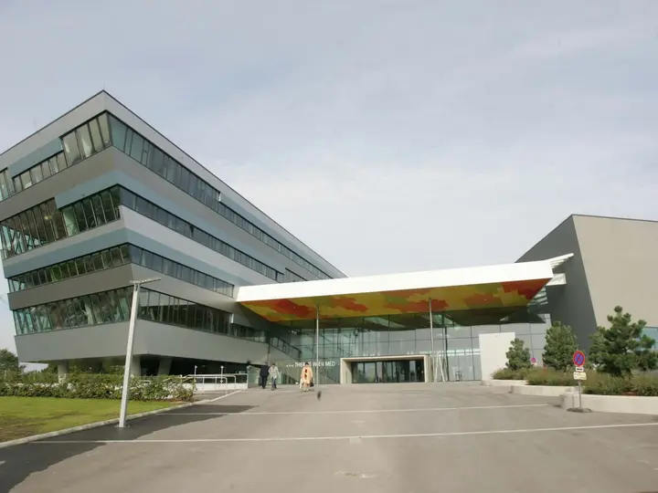 Modern angular glass facade and entrance canopy of Therme Wien in Oberlaa, Vienna