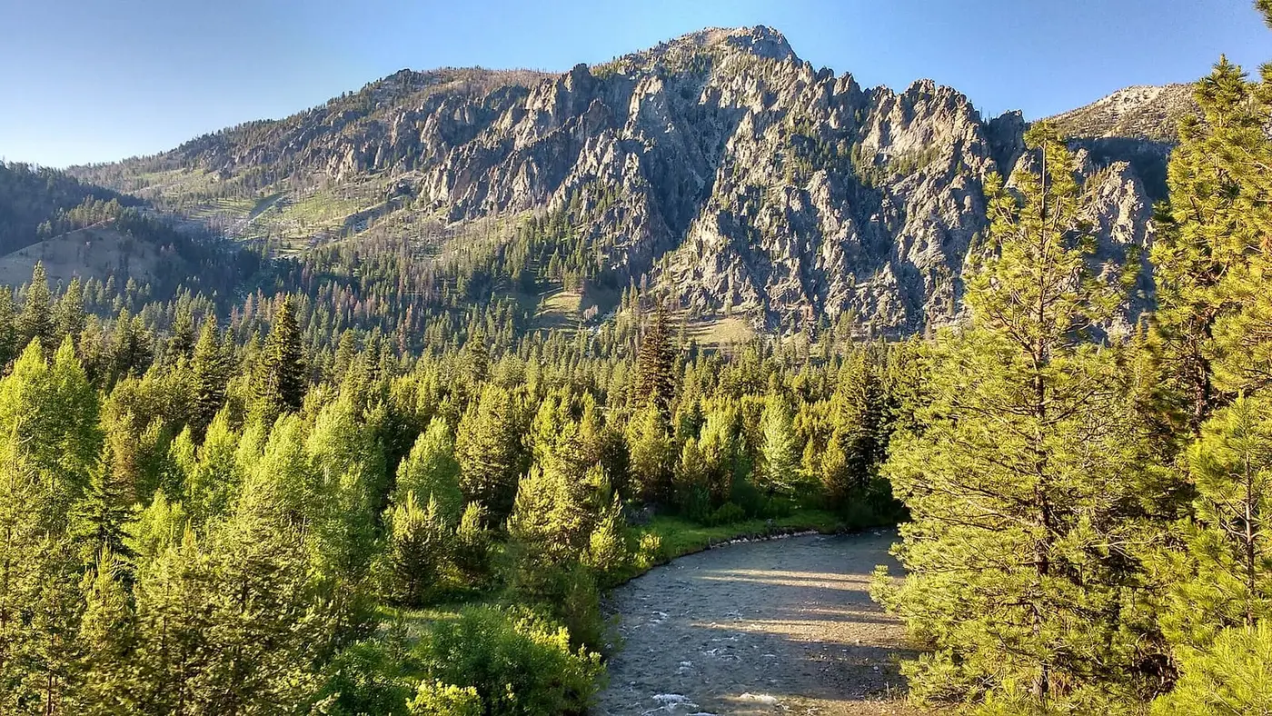 Middle Fork Boise River winding through pine forest below rugged peaks near Chattanooga Hot Springs
