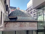 Ottoman dome of the Veli Bej Bath beside its modern glass wing in Buda