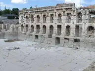 Arched stone facade of the Sarıkaya Roman Bath above its paved marble pool area