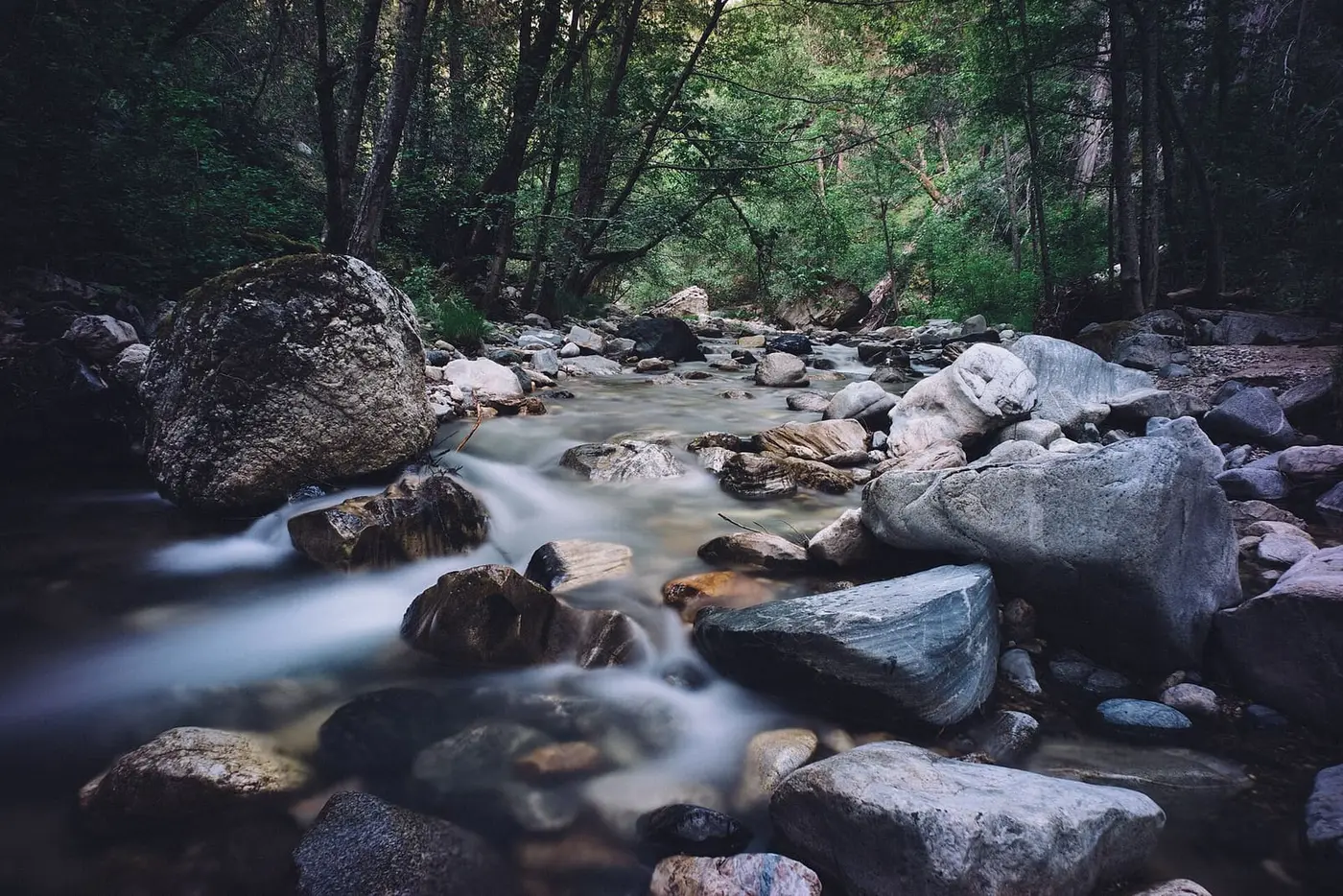 Big Sur River tumbling over mossy boulders in the forest near Sykes Hot Springs