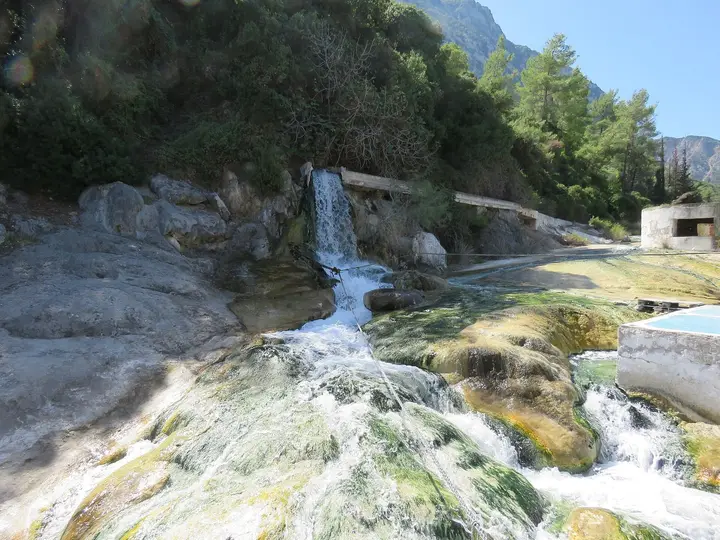 Hot sulphur water spilling over a small travertine waterfall at Thermopylae hot springs