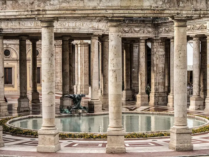 Colonnade around a round fountain pool inside the Terme Tettuccio at Montecatini